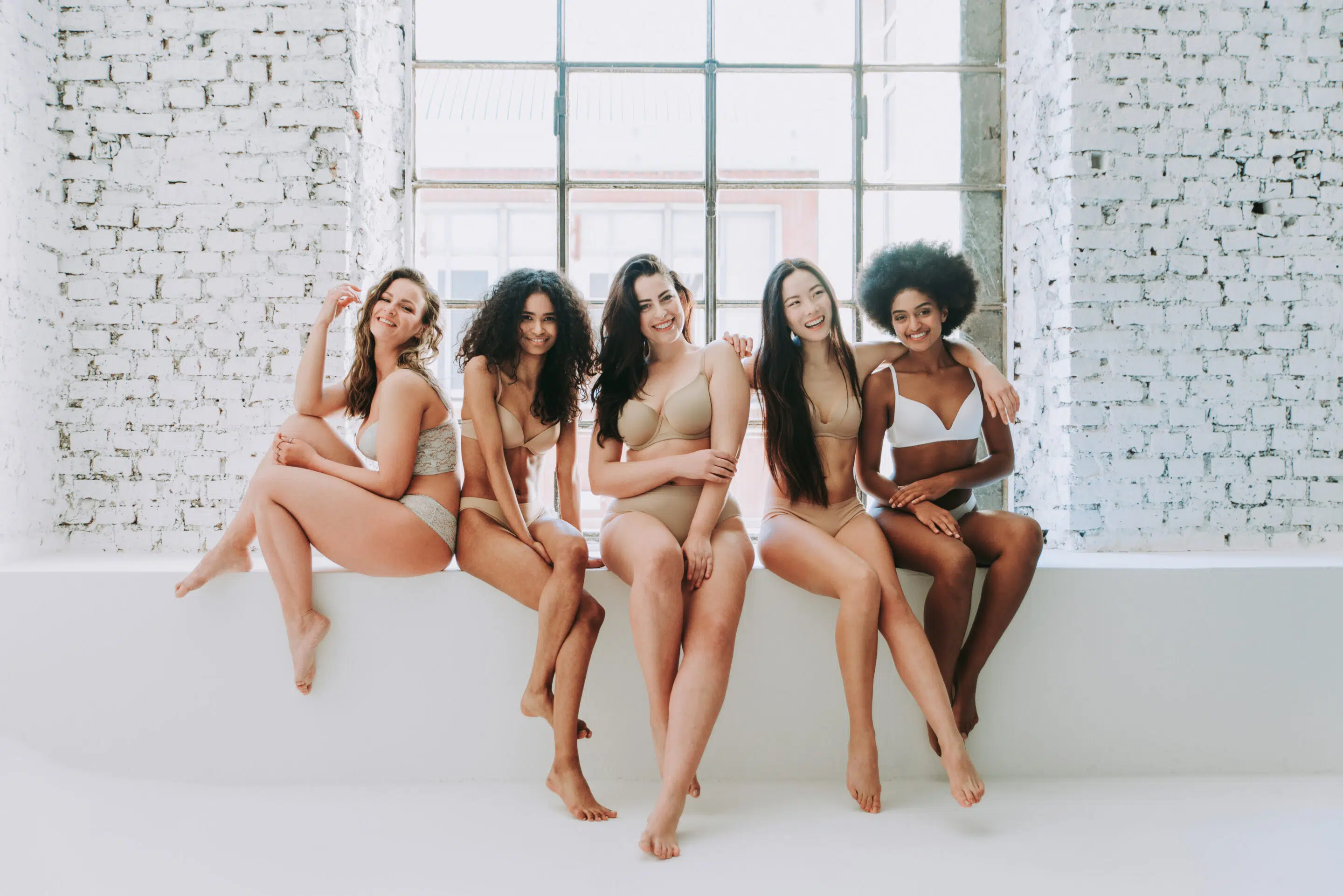 Group of women with different body and ethnicity posing together to show the woman power and strength. Curvy and skinny kind of female body concept manufacture of bra cups for lingerie
